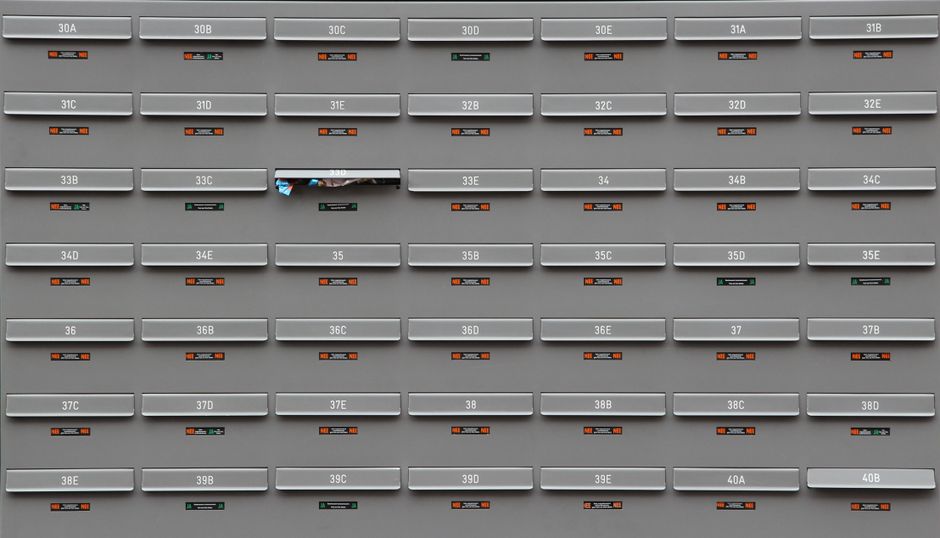 A grid of grey mailboxes with number labels showing an organized system.
