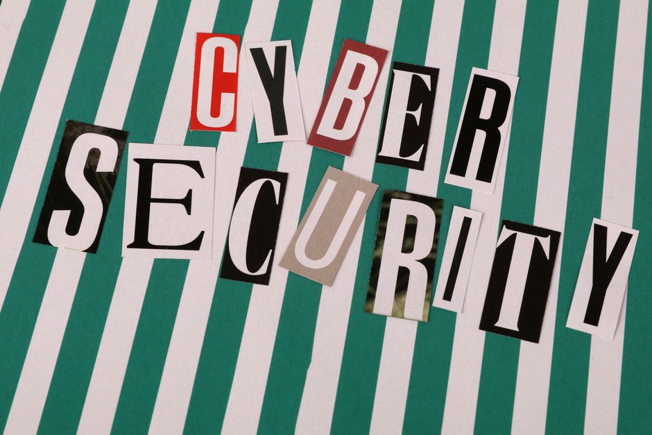 Colorful cutout letters spelling 'Cyber Security' on a striped background.