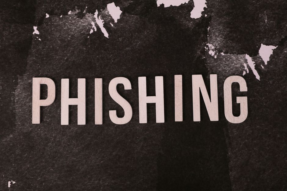Abstract representation of phishing with the text on a textured dark surface.