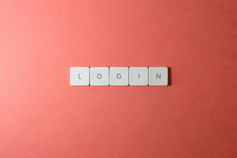 Close-up of login keyboard tiles on a coral background, perfect for tech themes.